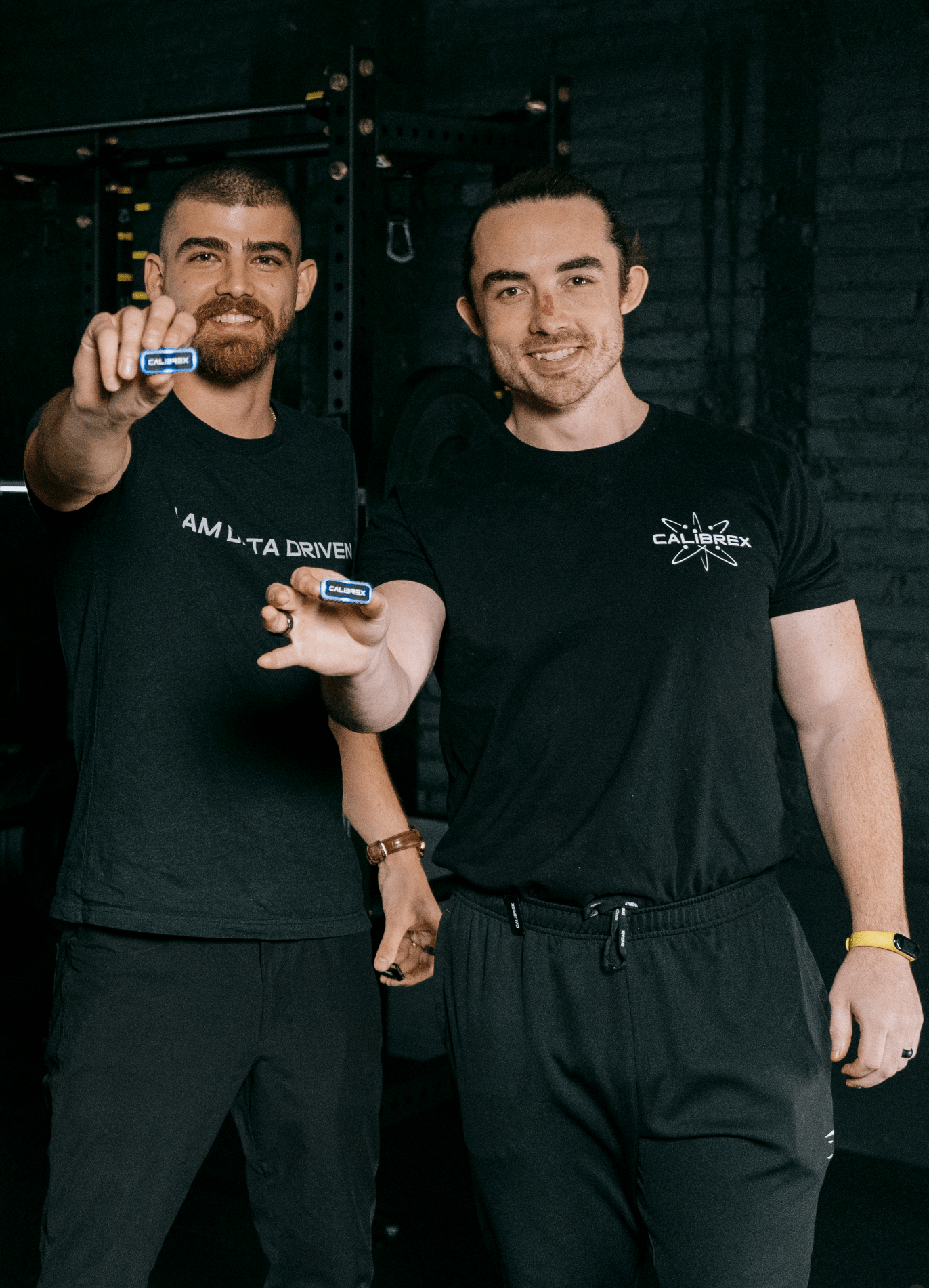 The Calibrex founders each holding up a Calibrex.